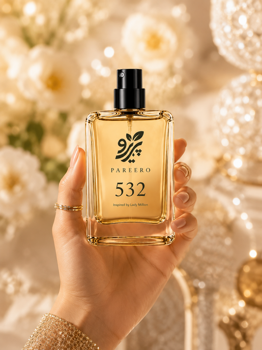 Hand holding PAREERO 532 Lady Million inspired fragrance in an elegant golden setting