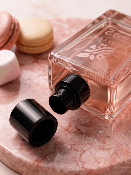 Close-up of the PAREERO 592 black atomizer, cap and blush fragrance bottle