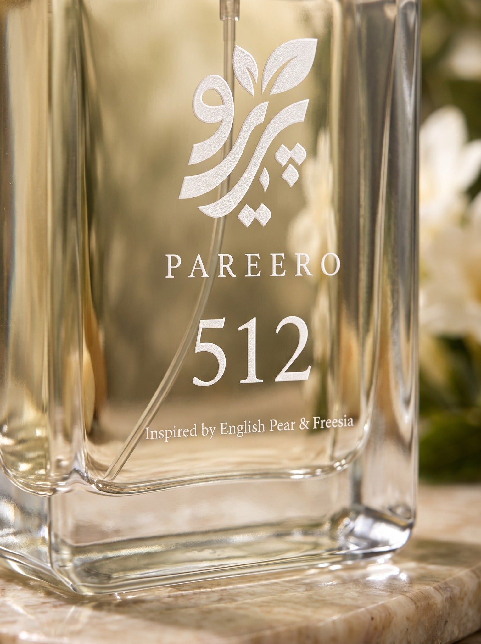 Macro detail of Pareero 512 perfume logo, clear glass bottle and pale golden fragrance
