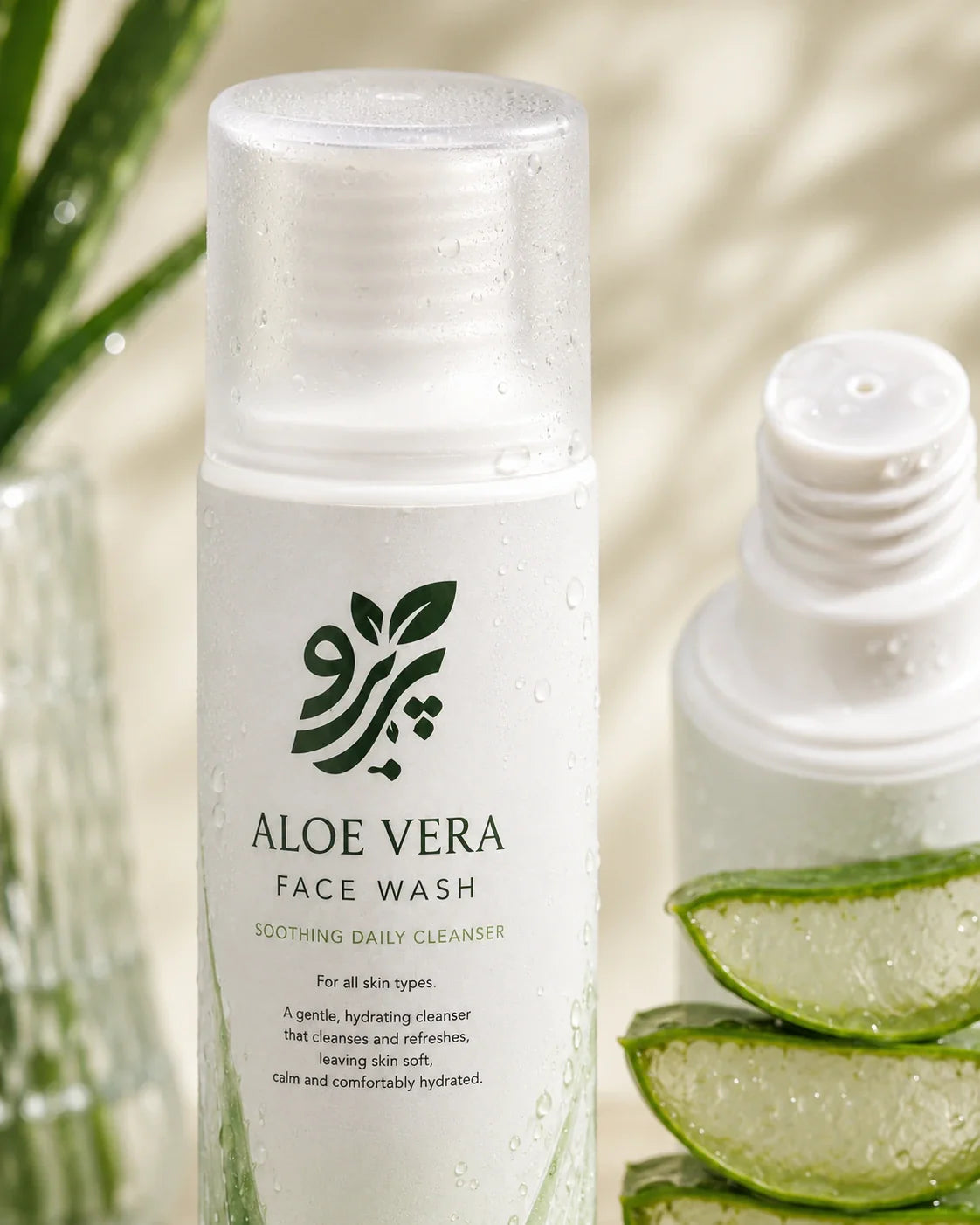 Close-up of Pareero Aloe Vera Face Wash bottle, frosted cap, nozzle, and aloe slices