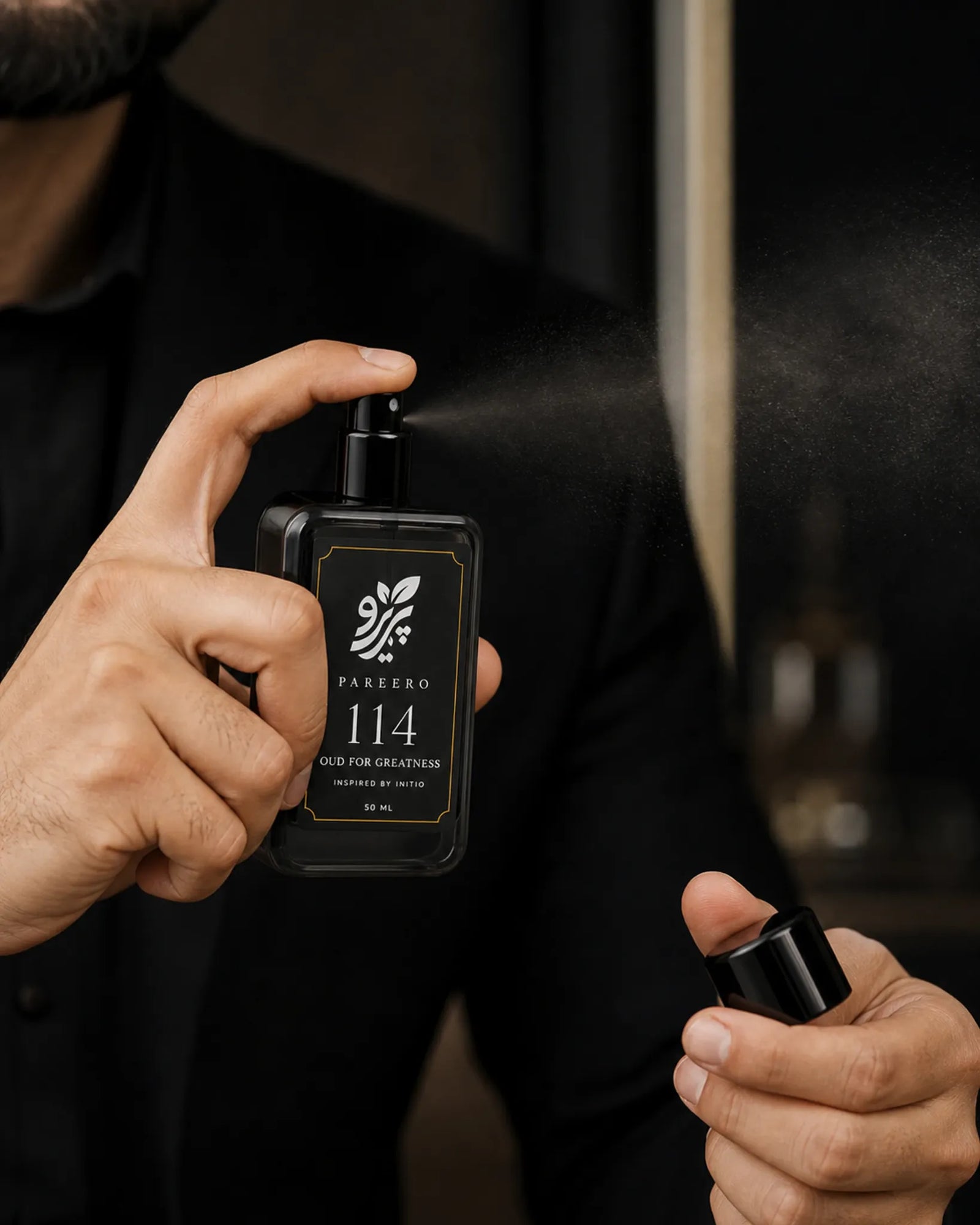 Man applying Pareero 114 inspired by Oud for Greatness fragrance spray