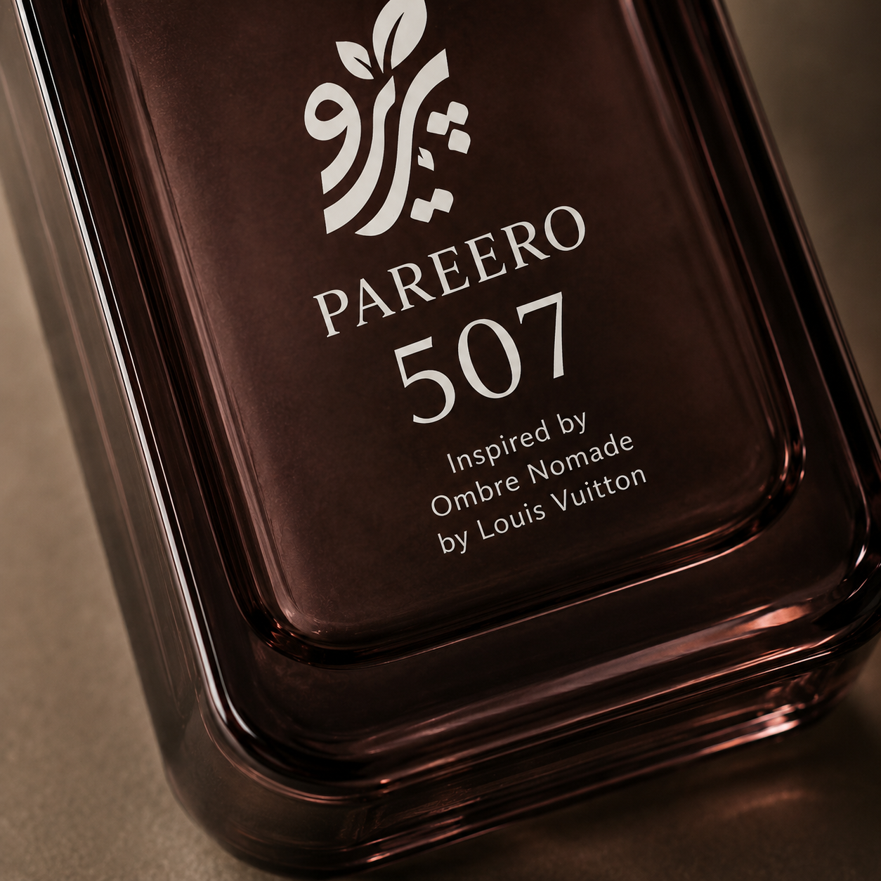 Macro detail of the PAREERO 507 fragrance bottle label and dark amber glass