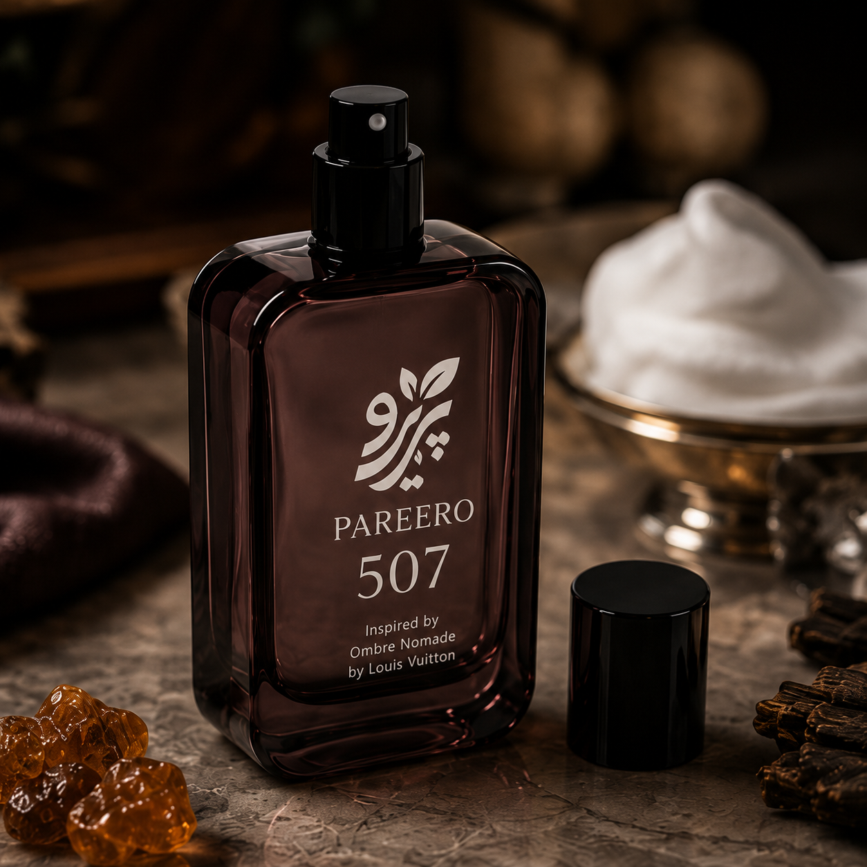 PAREERO 507 fragrance bottle with exposed black atomizer, cap, amber resin and oud wood