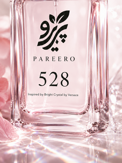 Macro detail of the PAREERO 528 fragrance label and luminous pink glass bottle
