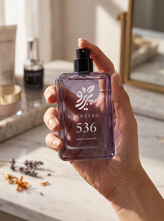 Hand holding PAREERO 536 Libre-inspired fragrance in warm natural light