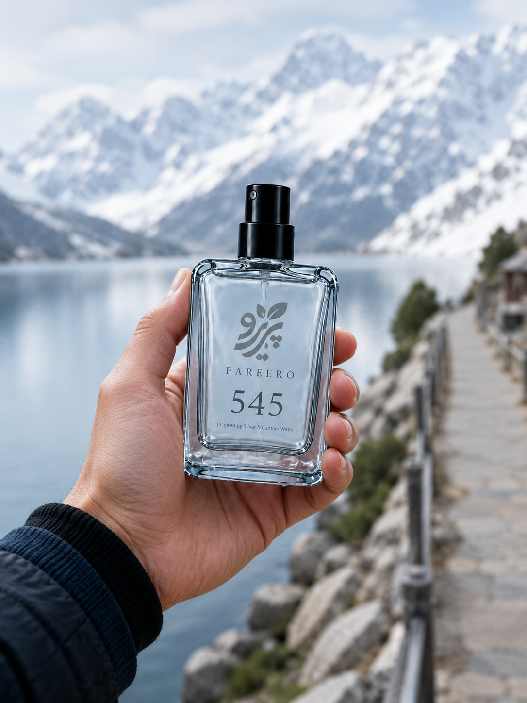 PAREERO 545 Silver Mountain Water inspired fragrance held in hand on a mountain lakeside path