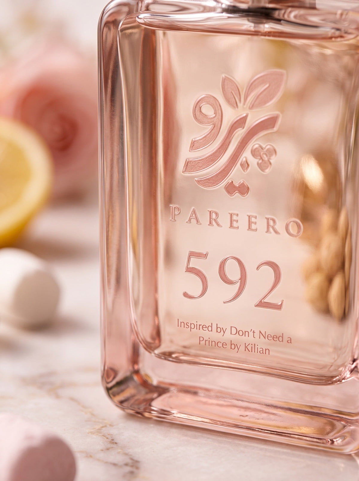 Macro view of the rose-toned PAREERO 592 logo, typography and glass bottle