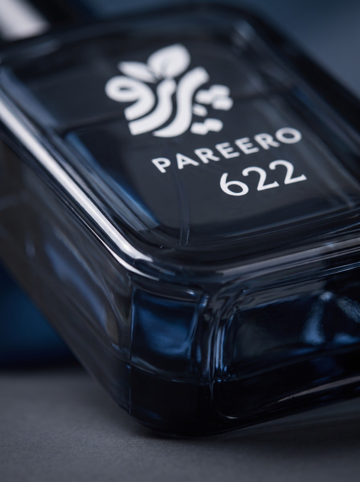 Macro detail of PAREERO 622 inspired by Bleu de Chanel bottle branding and deep blue glass